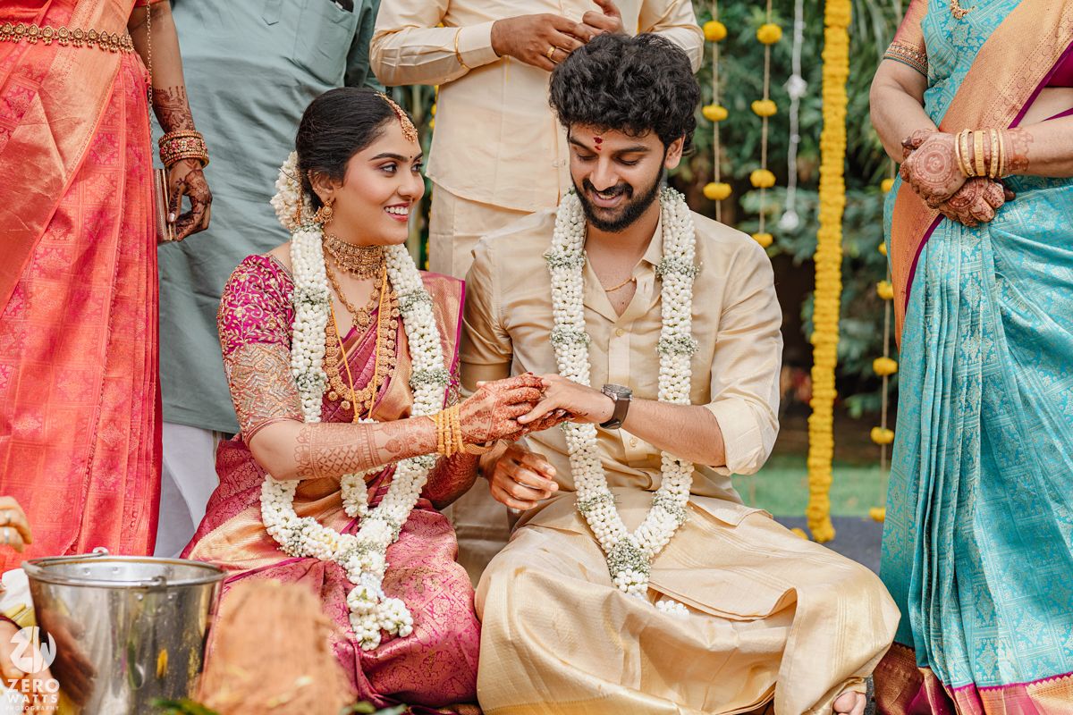 Traditional South Indian wedding ceremony with yellow marigold decorations and traditional attire.