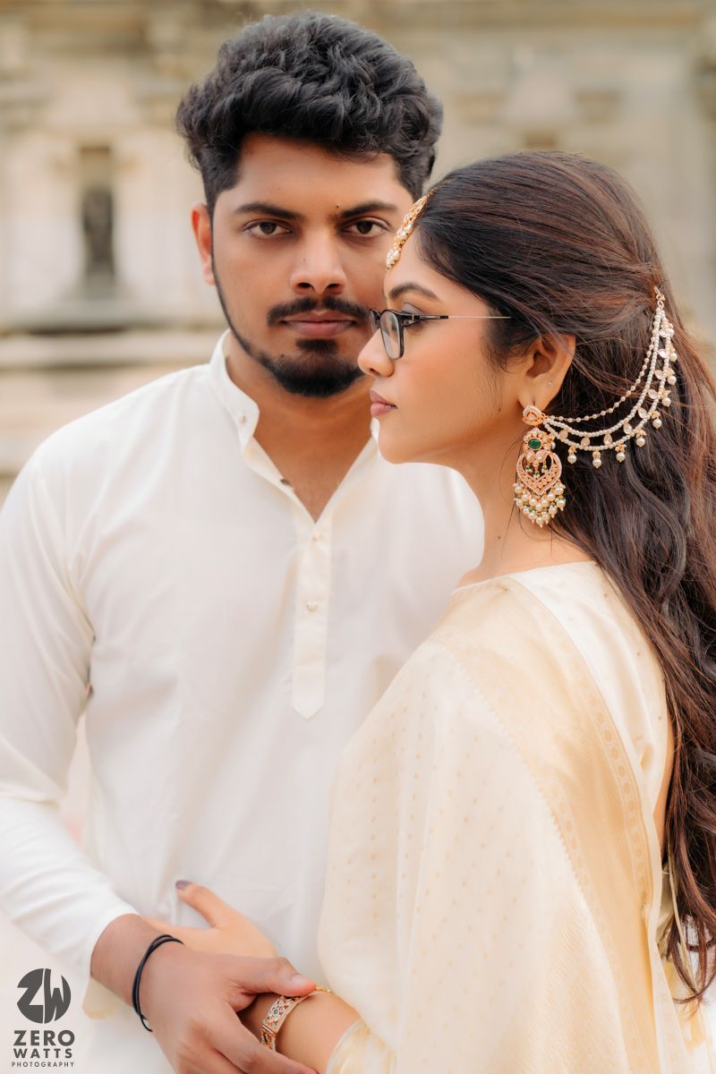 A romantic couple in traditional Indian attire pose together against a light background in a series of intimate shots.