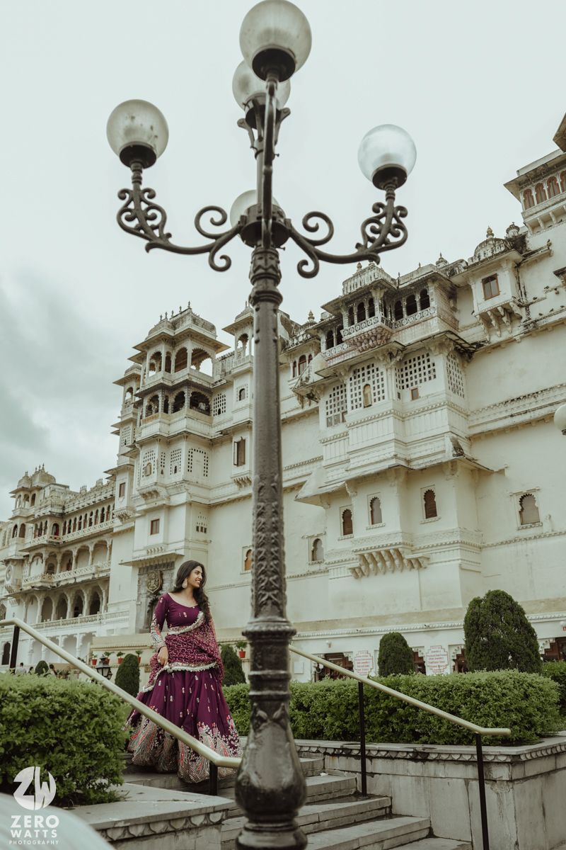 Moody architectural shot featuring traditional Indian palace and decorative street lamp in Udaipur.