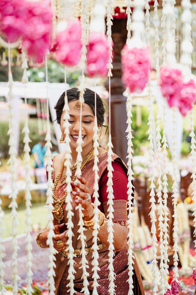 Wedding celebration with hanging crystal strands and pink floral decorations creating a dreamy ambiance.