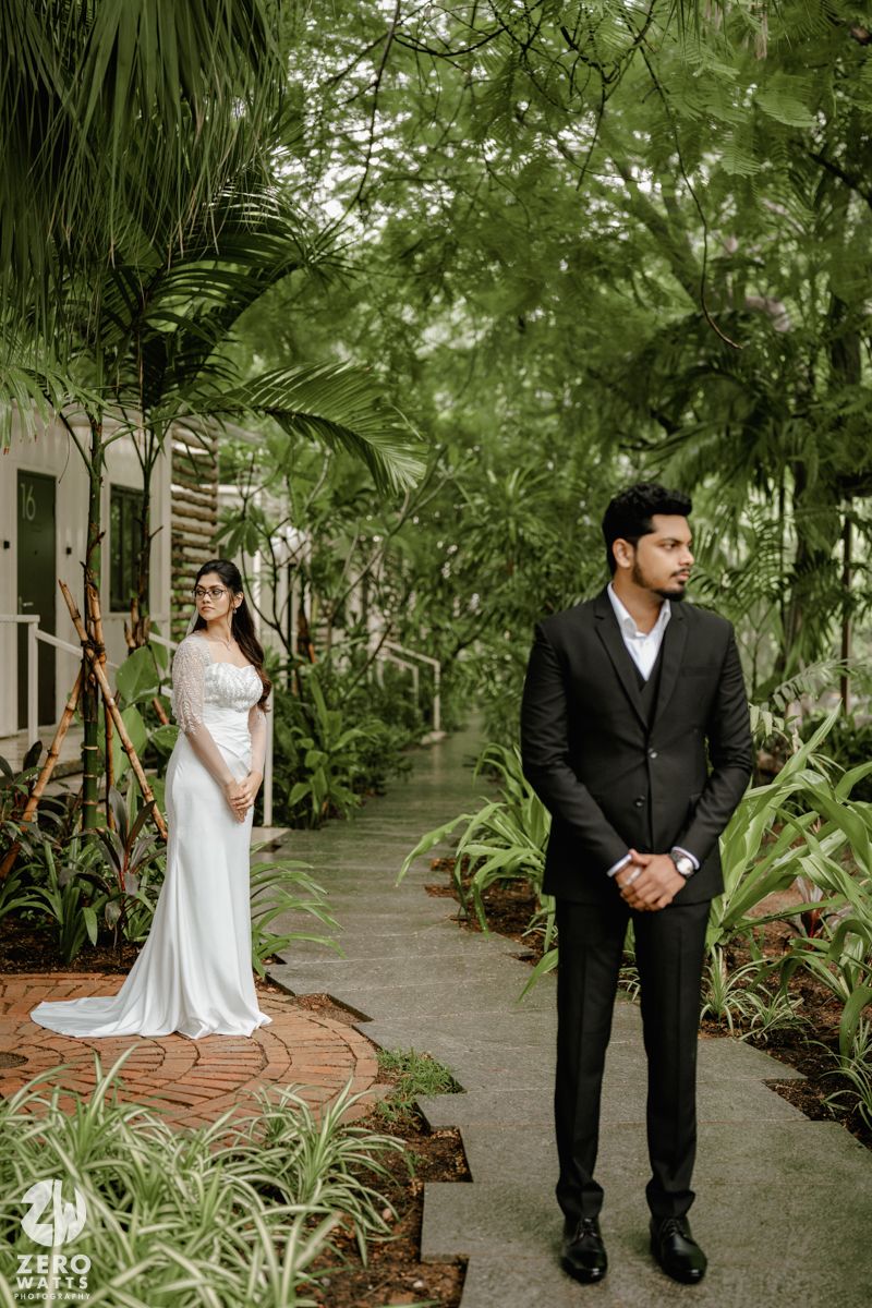 A romantic wedding photo series in a lush tropical garden setting with palm trees and stone pathways.
