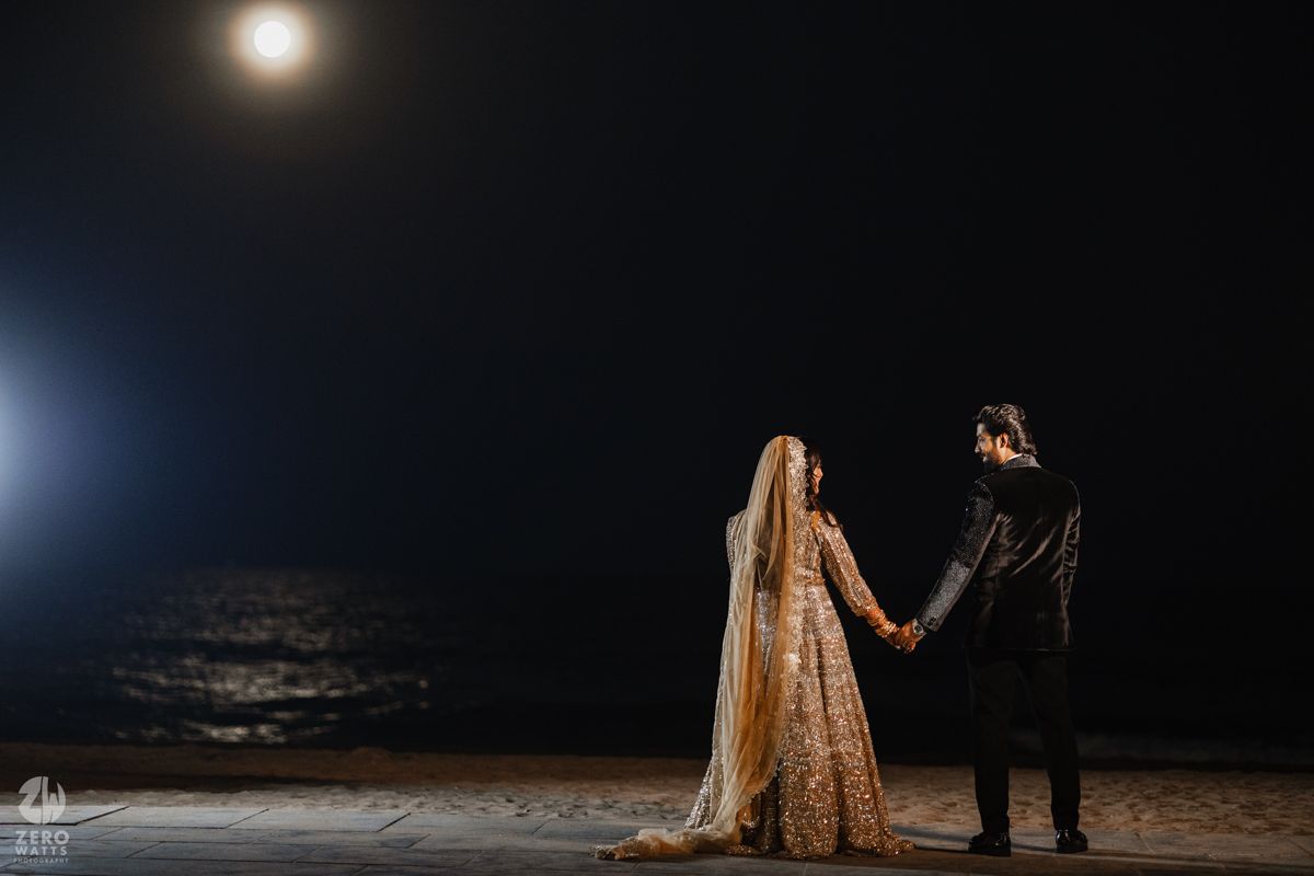 Silhouettes against a moonlit night sky creating a dramatic wedding photography composition.