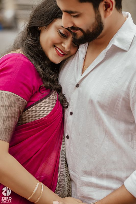 Romantic couple in traditional Indian attire sharing intimate moments against a temple backdrop.