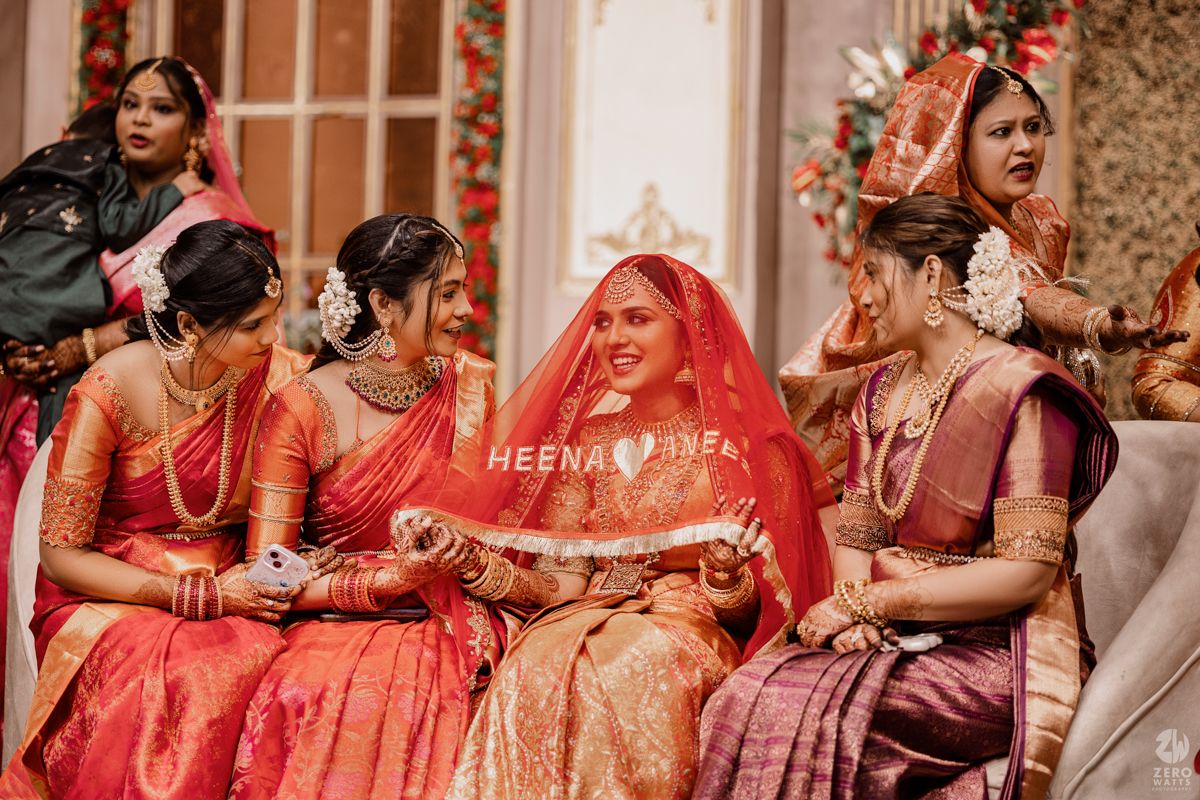 Wedding guests in vibrant traditional Indian attire seated together during ceremony celebrations.