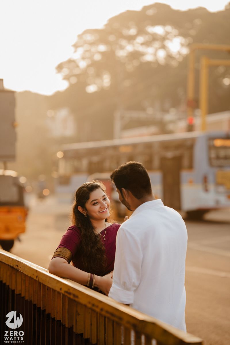 A romantic sunset moment captured at a historic railway station with warm golden lighting.