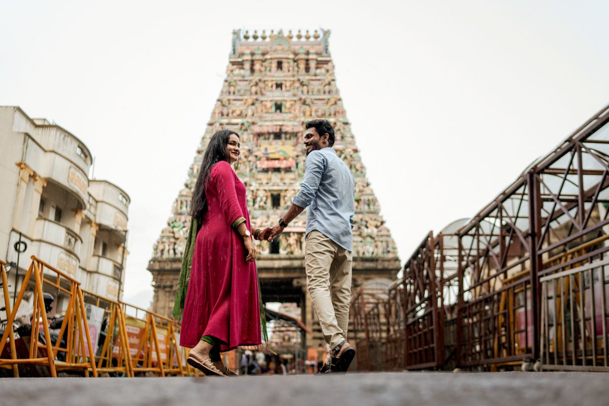 Architectural engagement photos featuring a couple posing on rustic bridges with temple backdrop.