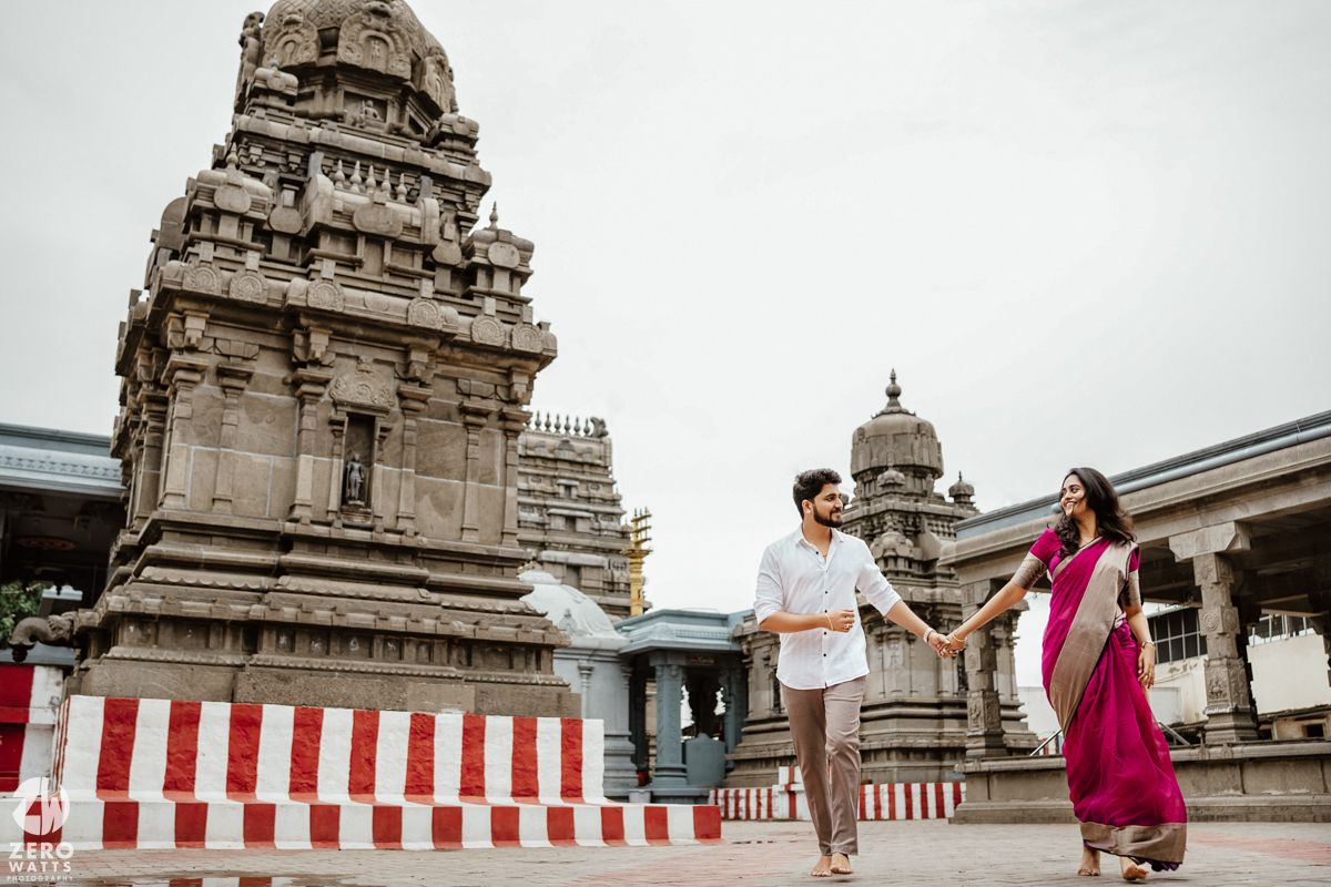 Traditional temple complex with red and white striped barriers visible in the foreground.