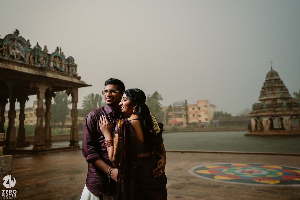 Couple shares intimate moments against the backdrop of temple architecture at sunset.