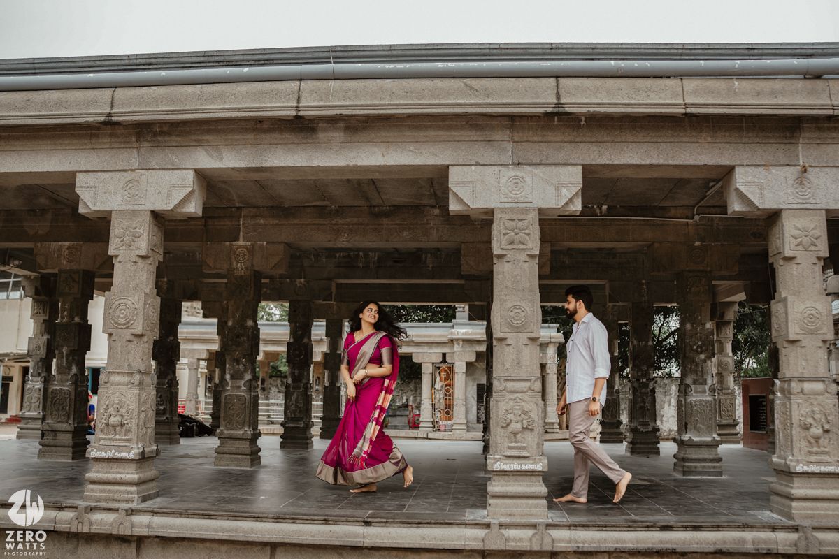 Ancient stone pillars and archways create a dramatic architectural corridor.