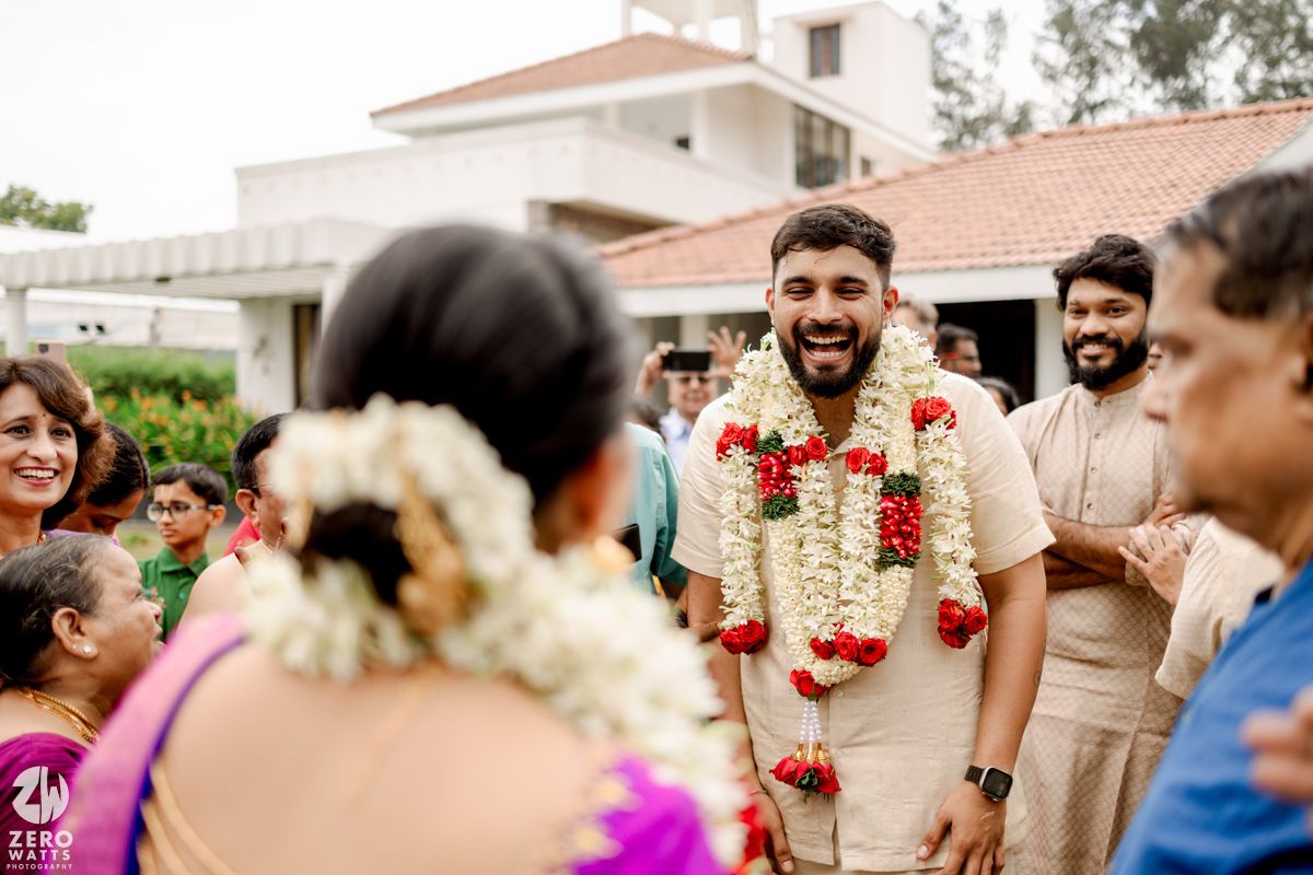 Outdoor wedding celebration with guests and decorative floral arrangements.