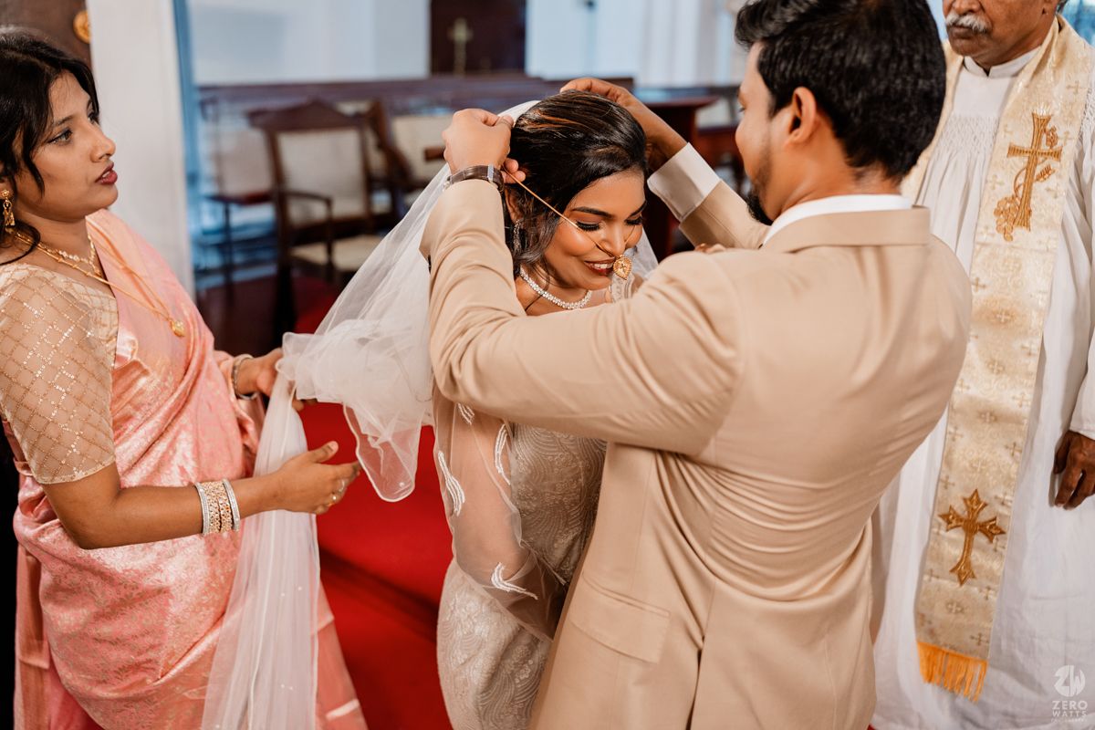 Wedding reception guests dancing and celebrating together in a festive atmosphere with warm lighting.
