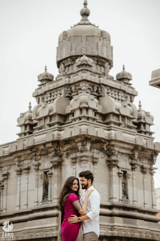 Beautiful Indian temple architecture with ornate domes and pillars against a white sky.
