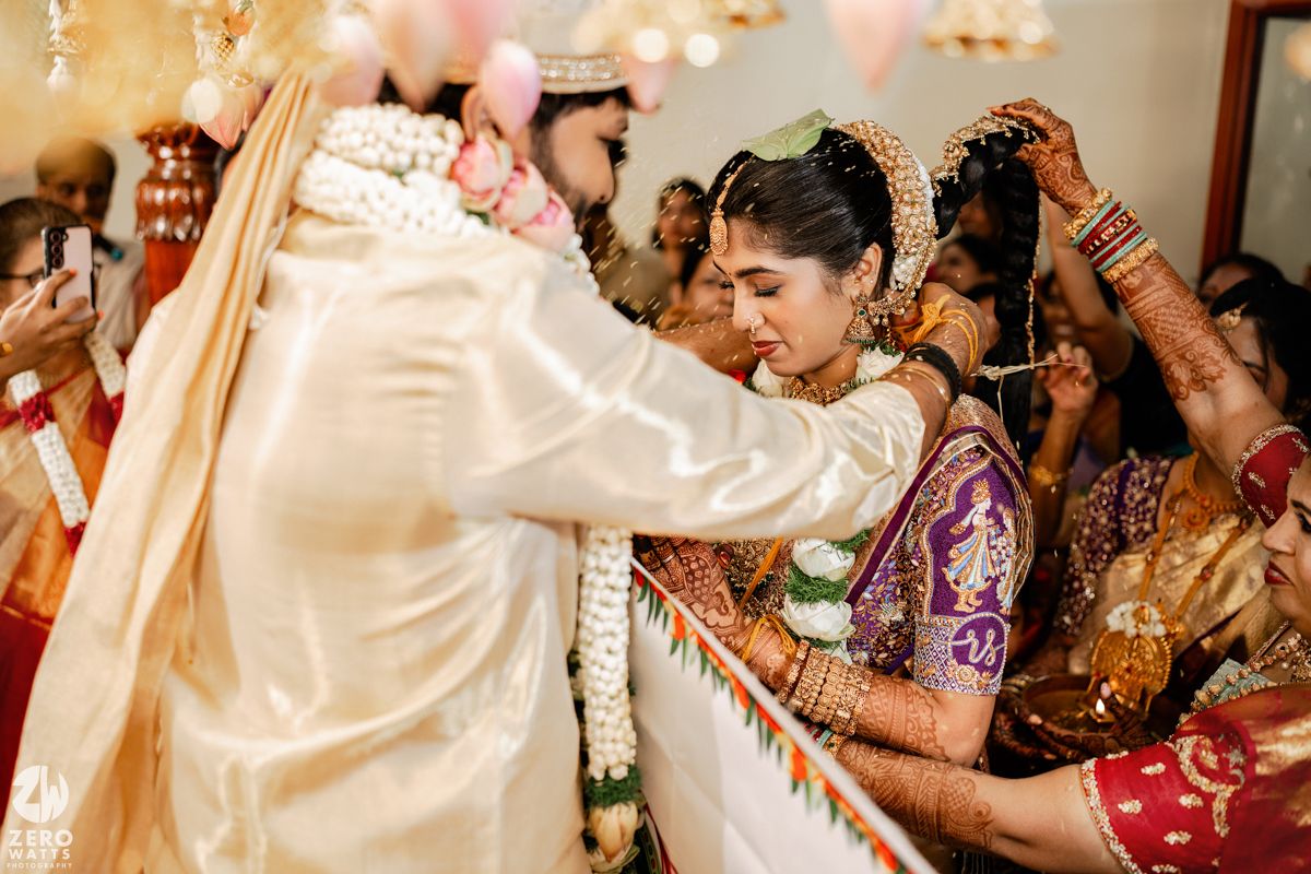 Traditional wedding ceremony with guests participating in cultural rituals.