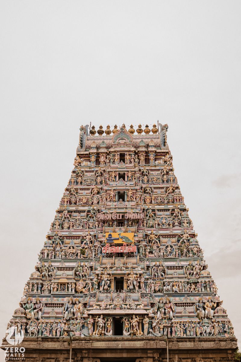 Ornate temple gopuram architecture with intricate stone carvings and multiple tiers in traditional South Indian style.