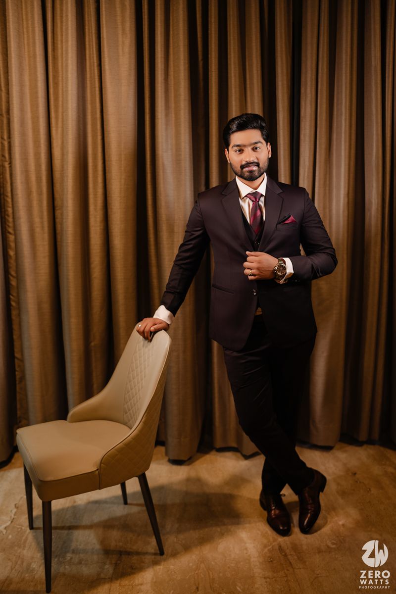 Series of artistic portrait shots against brown curtain backdrop in formal black suit.