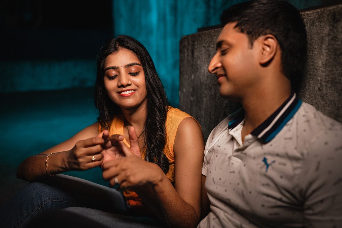Romantic couple sharing intimate moments against a blue-tinted background.