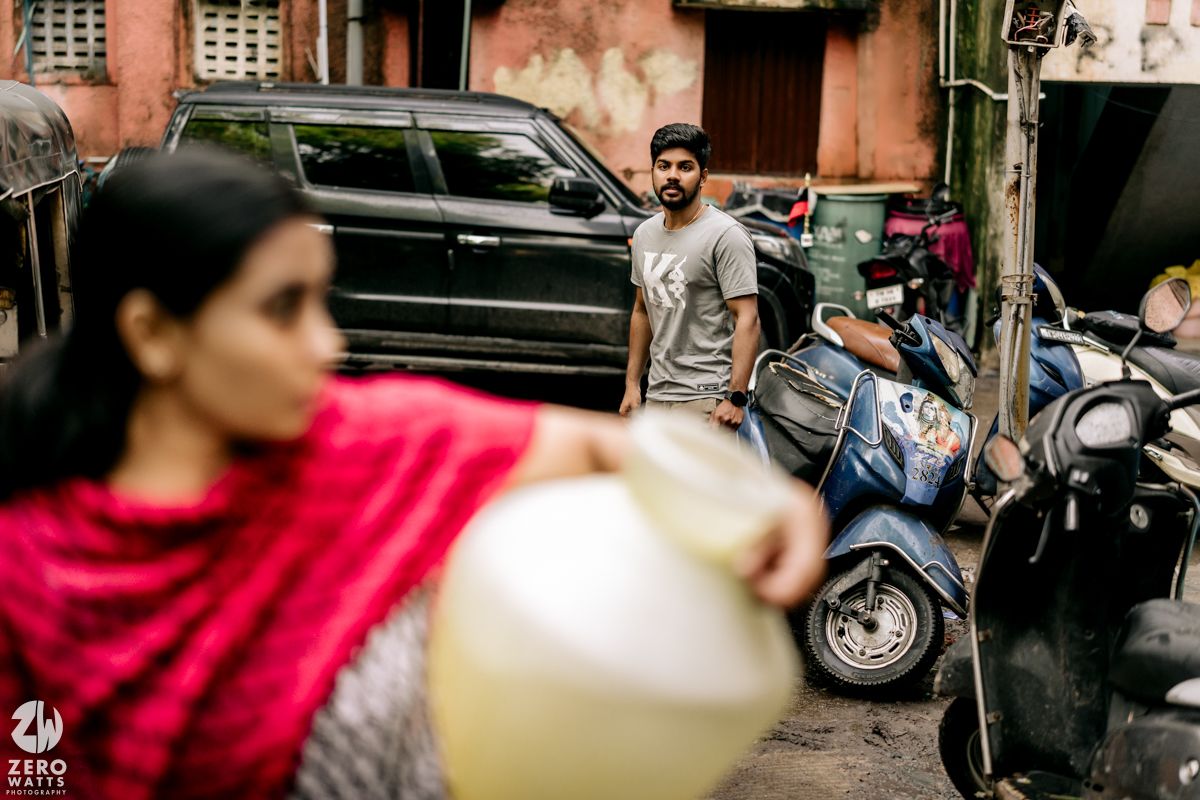 Street photography showing cars and motorcycles parked along an urban residential area.