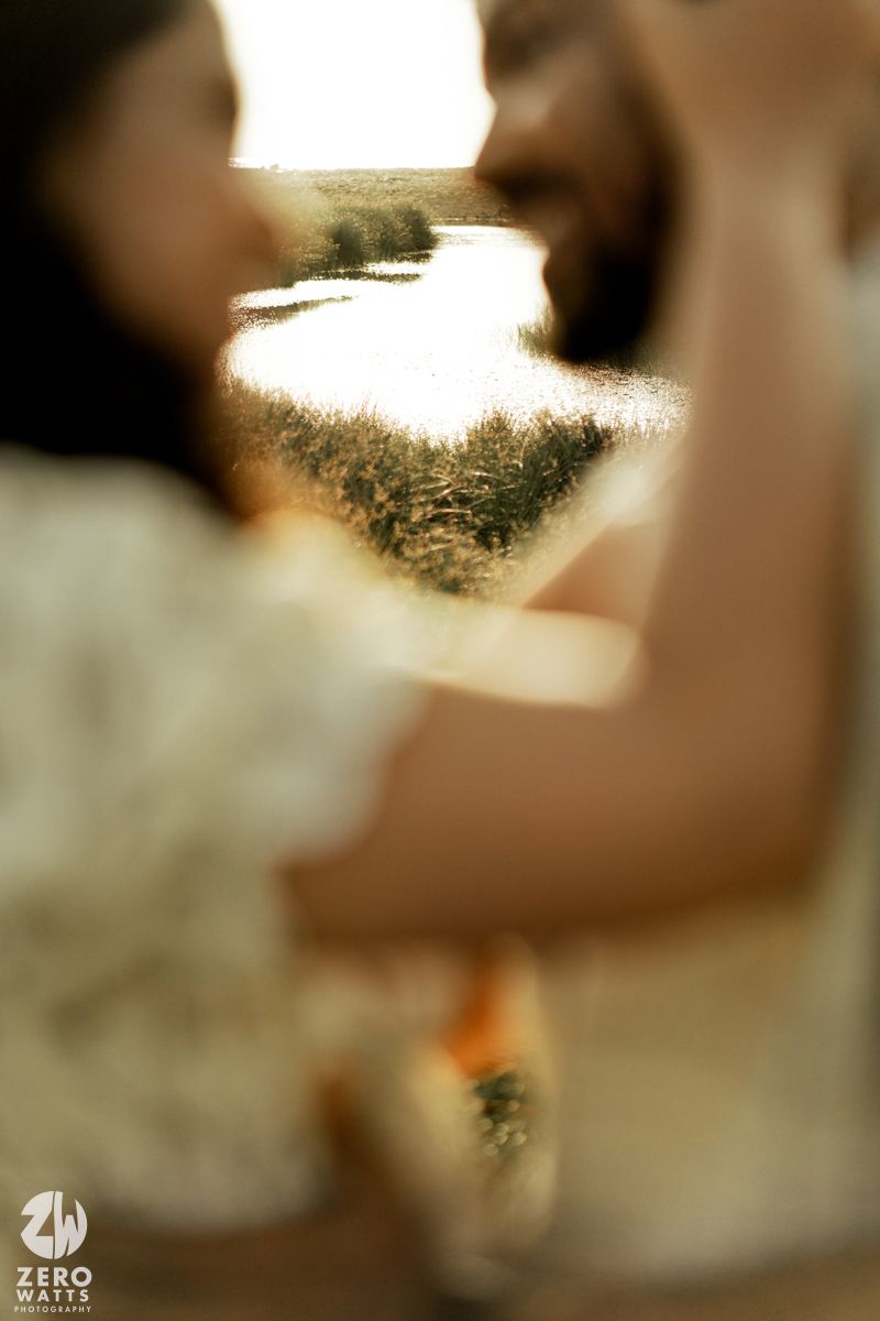 Abstract blurred brown and cream colored background with soft bokeh lighting effects and circular shapes.