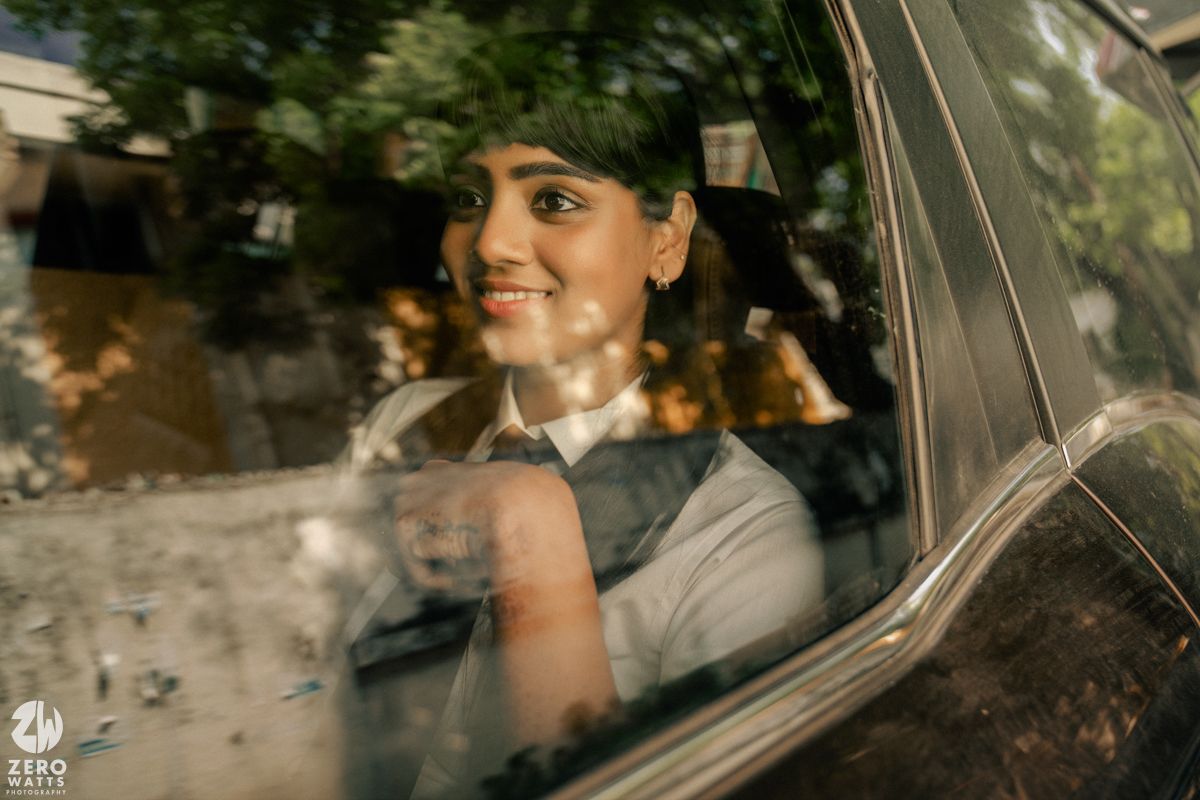 Candid moment captured through a car window with natural lighting.