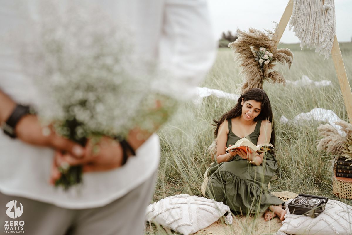 Couple shares intimate moments against rustic wooden backdrop with boho wedding decor.