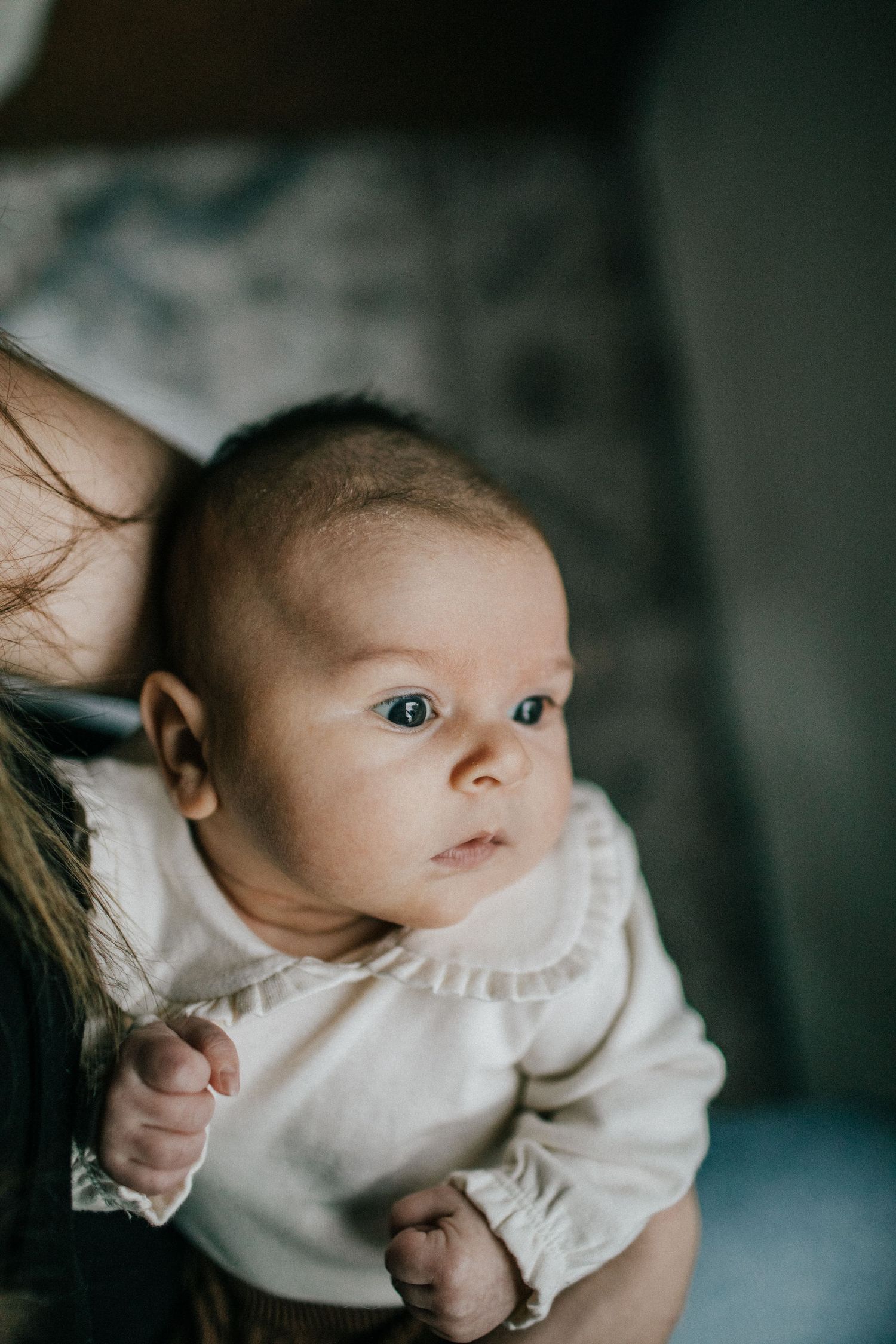 Image of a baby looking out a window.