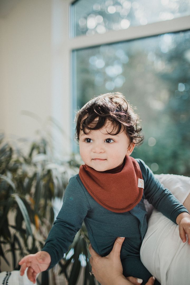 Image of a baby boy looking into the distance.