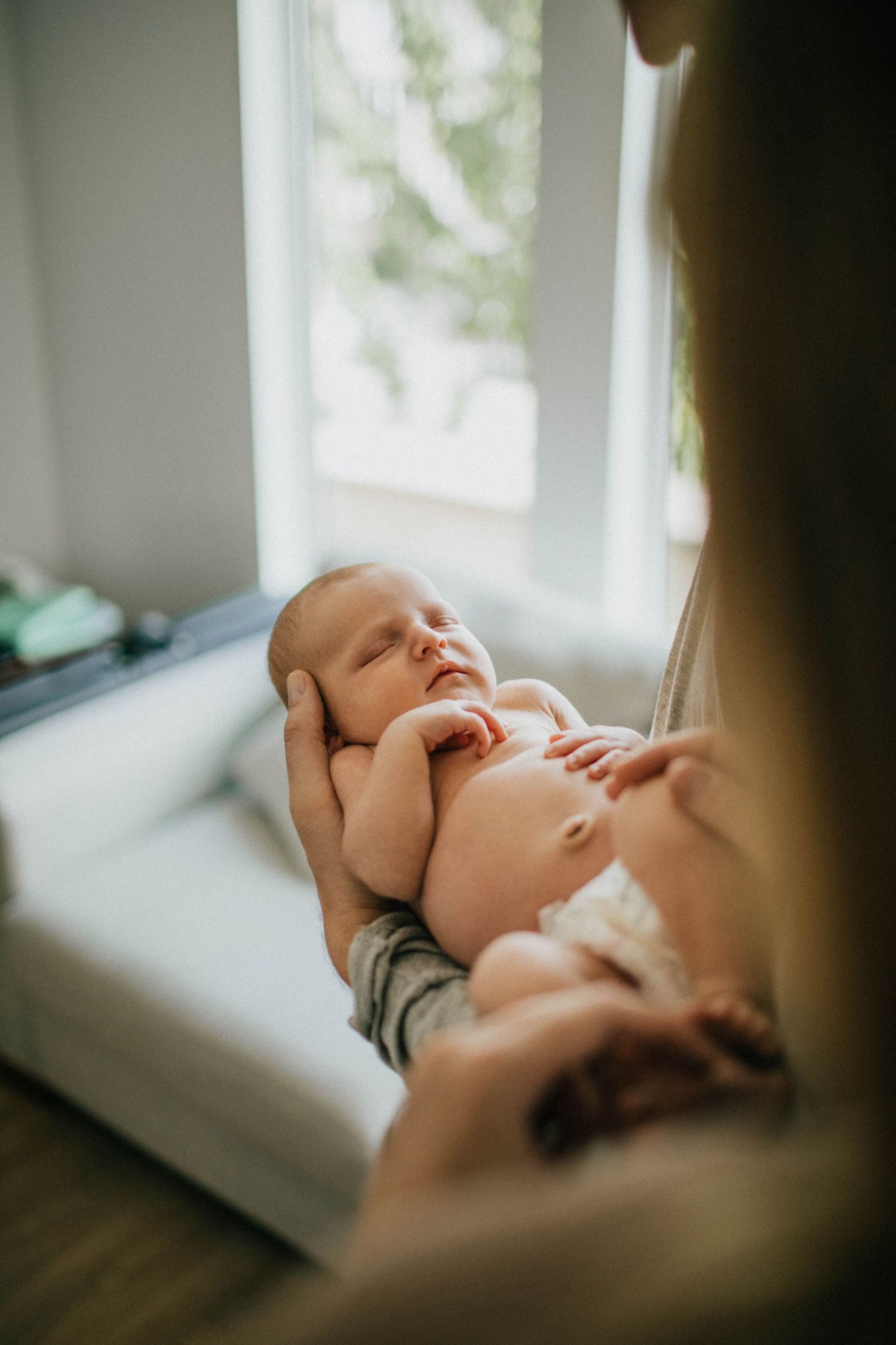 Image of newborn baby girl being held by dad.