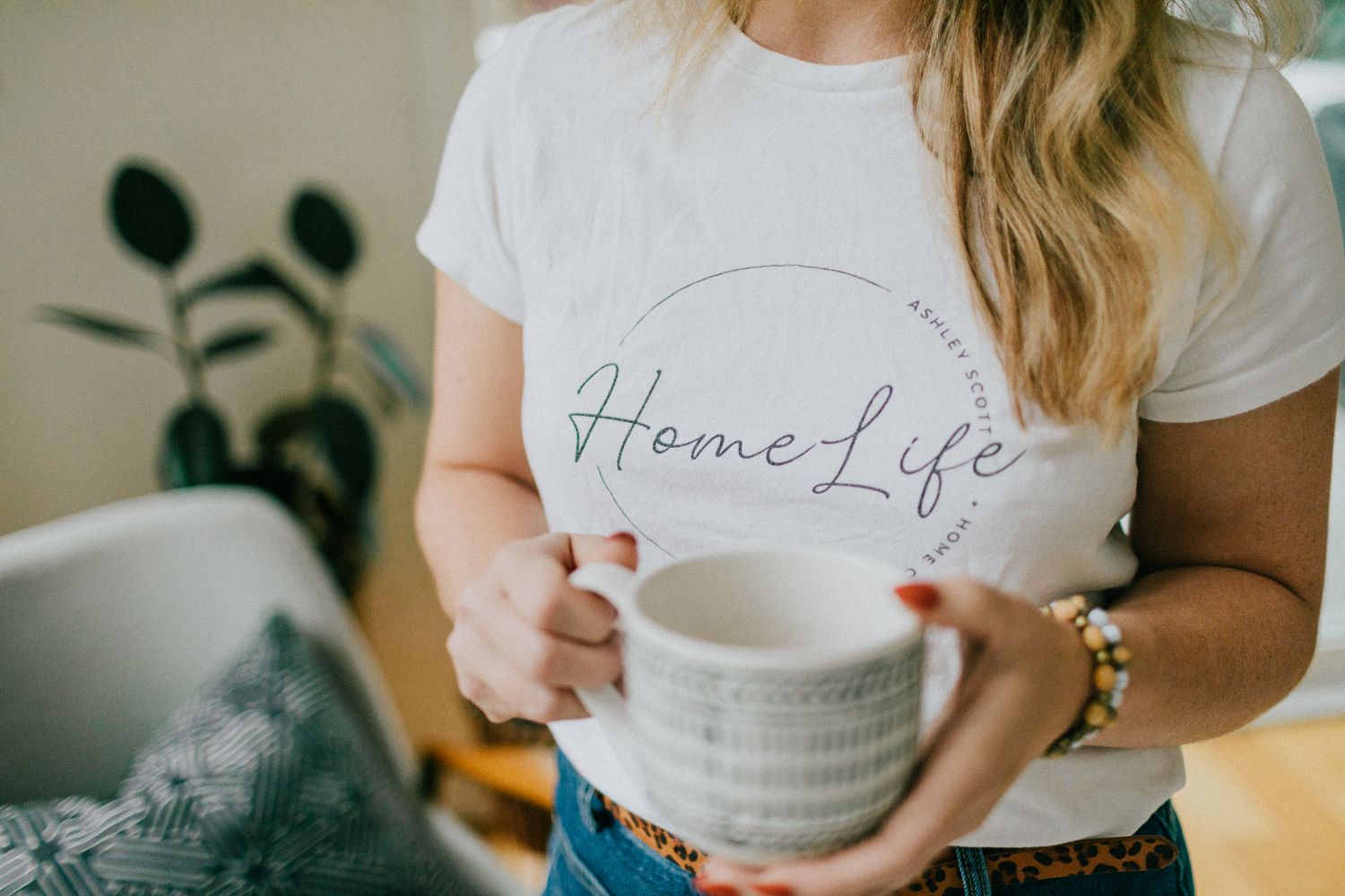 Closeup image of a brand logo, titled Ashley Home Life, on a t-shirt.