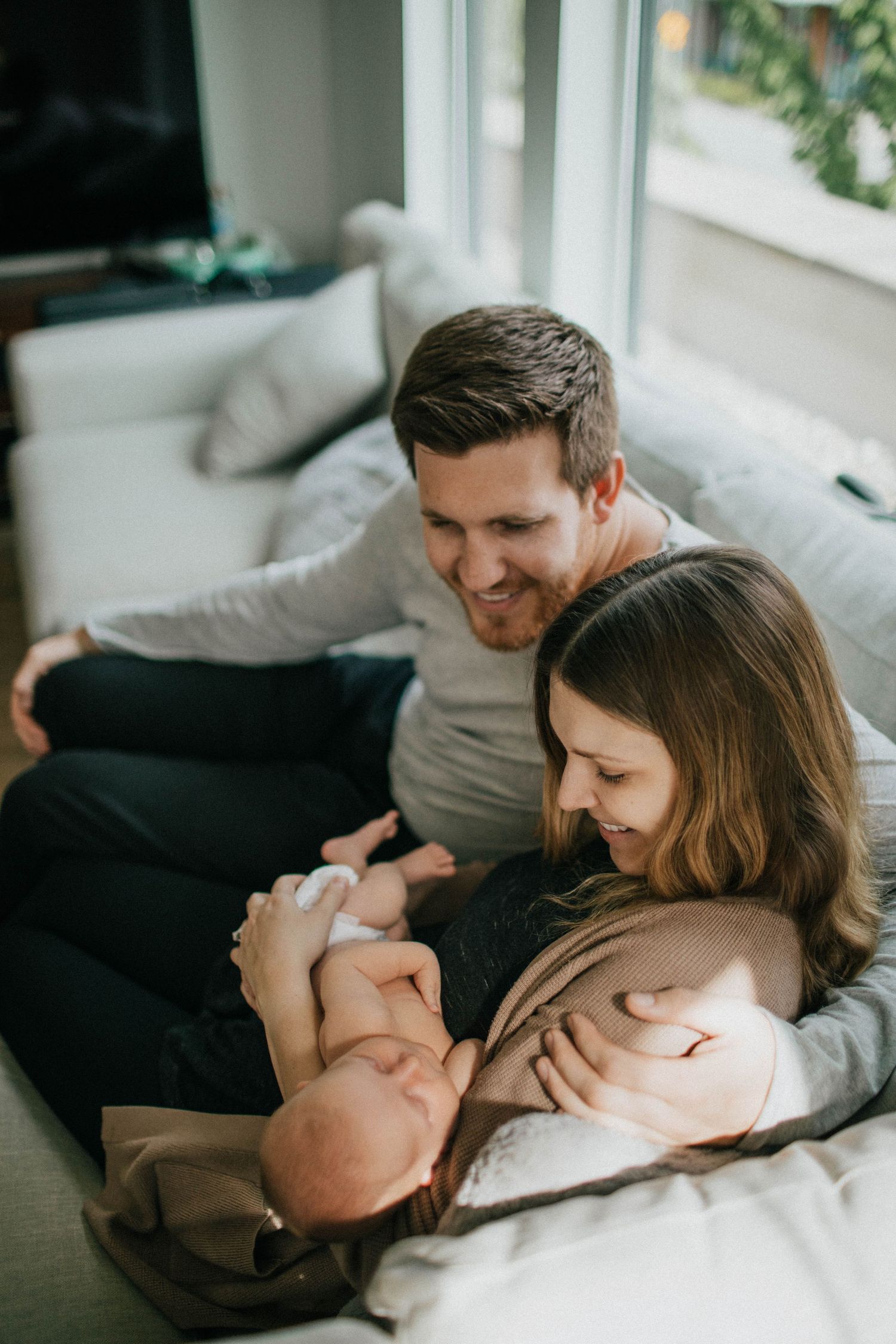 Image of mom and dad looking at newborn baby girl.