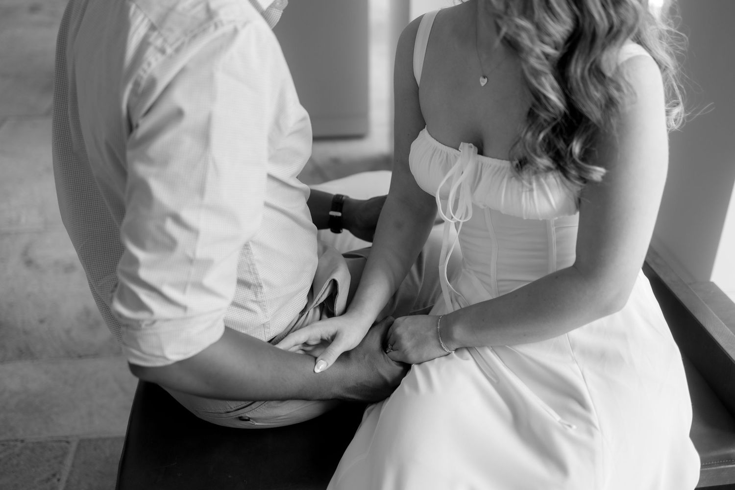 A black and white photo collage showing tender moments between a bride and groom during their wedding celebration.