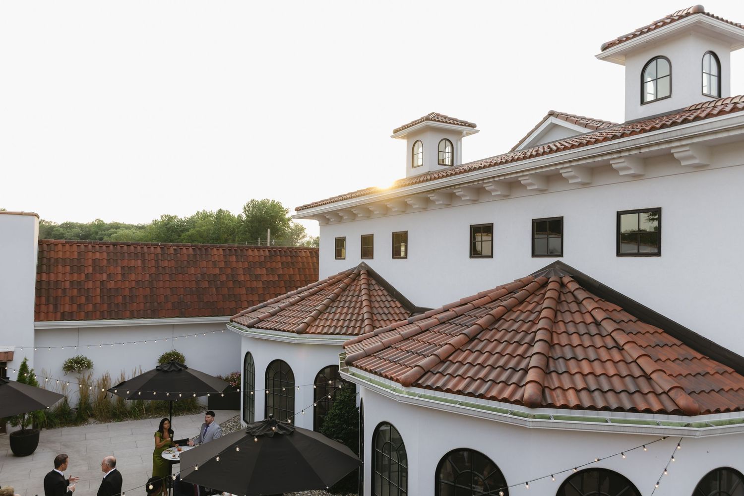 Spanish colonial style architecture with white stucco walls and terracotta tile roofs stretches across a panoramic view.