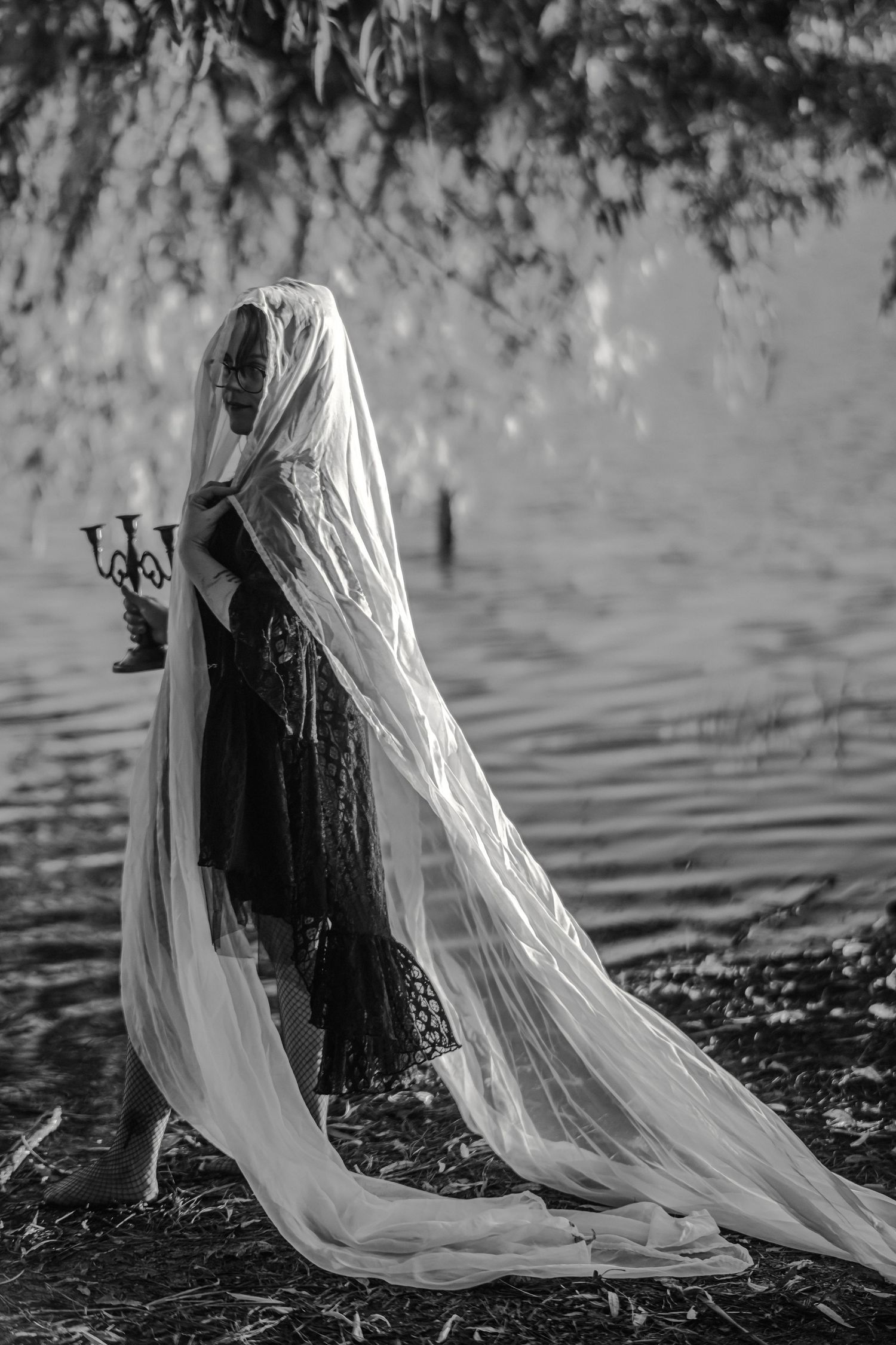 A series of black and white photos showing a flowing white veil cascading in water with gothic, ethereal ambiance.
