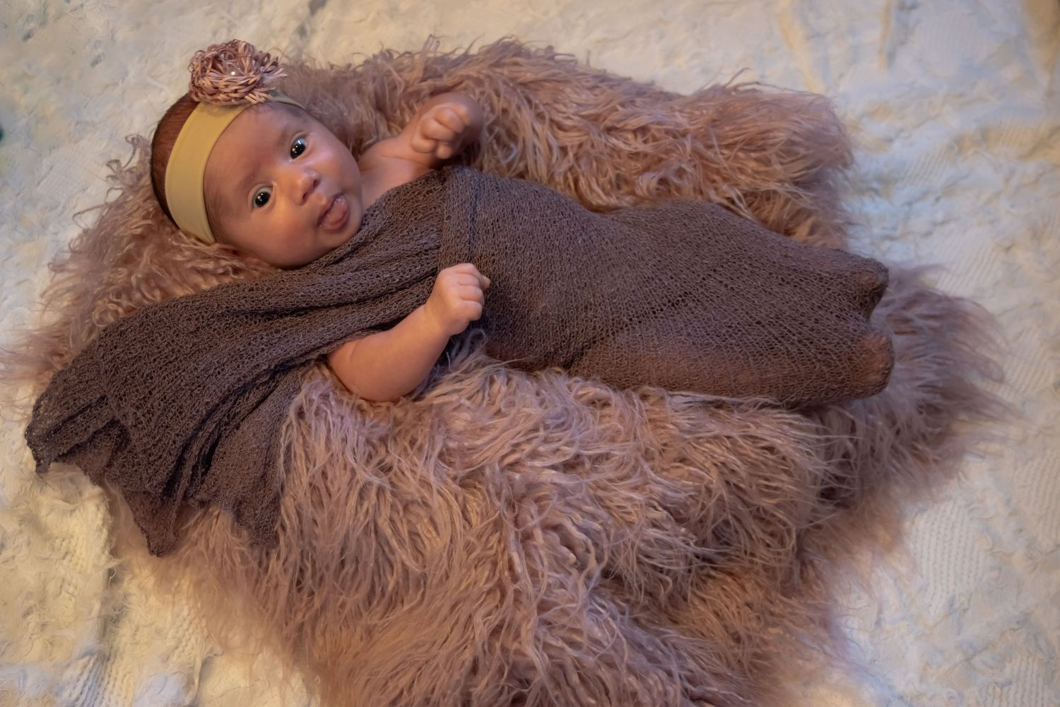 Brown baby potato plush toy lying on a cozy fluffy blanket or rug showing multiple poses.