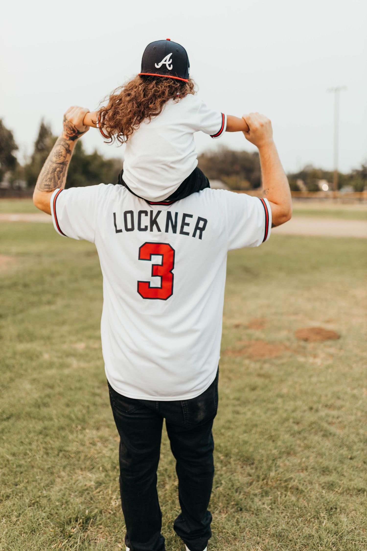 Couple walking hand in hand during an outdoor couples photography session captured by Breanna Watts Photography.