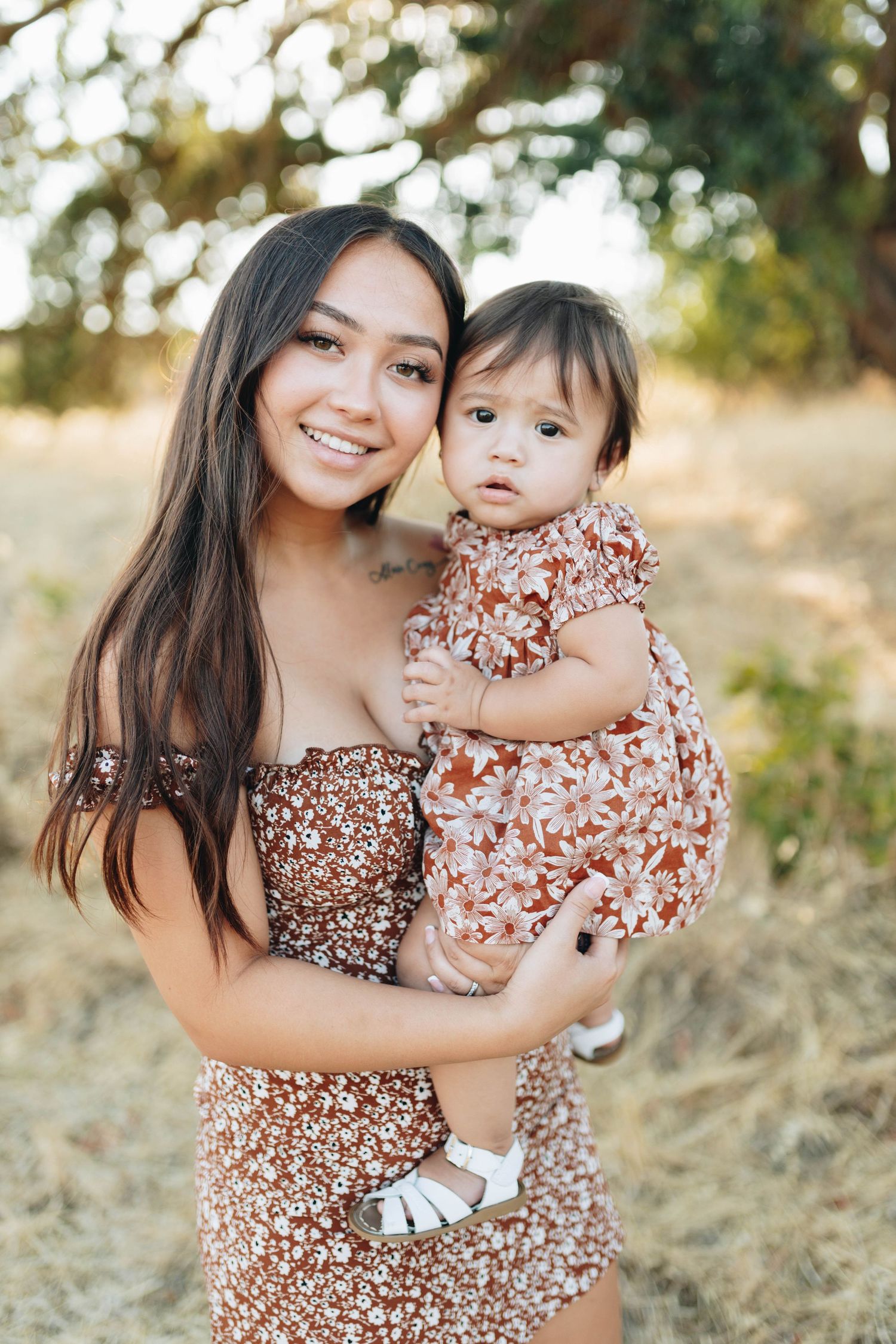 Mother holding her toddler during a natural outdoor family photography session photographed by Breanna Watts Photography.