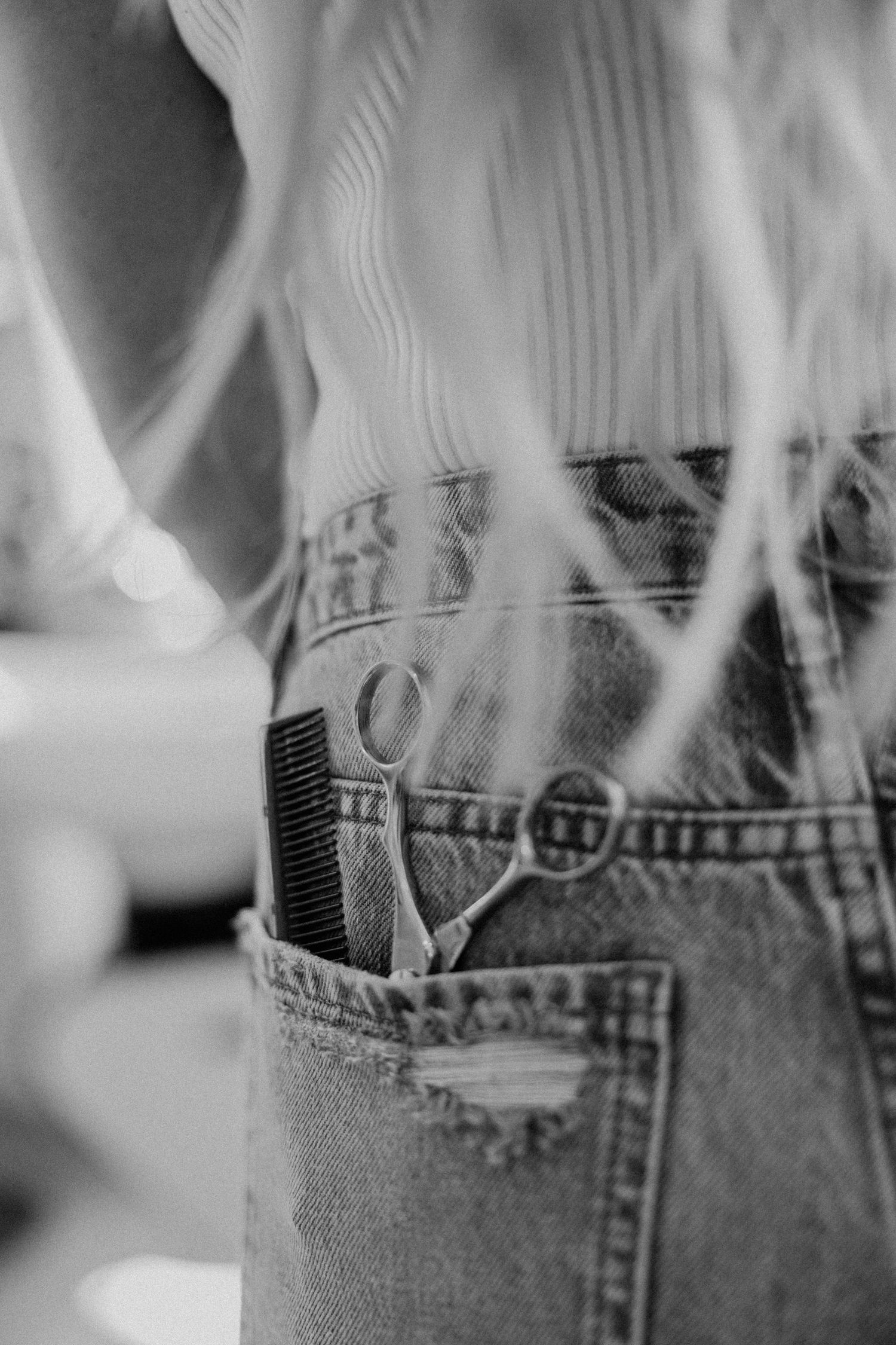 Close-up black and white photo of denim jeans pocket with smoke effects.