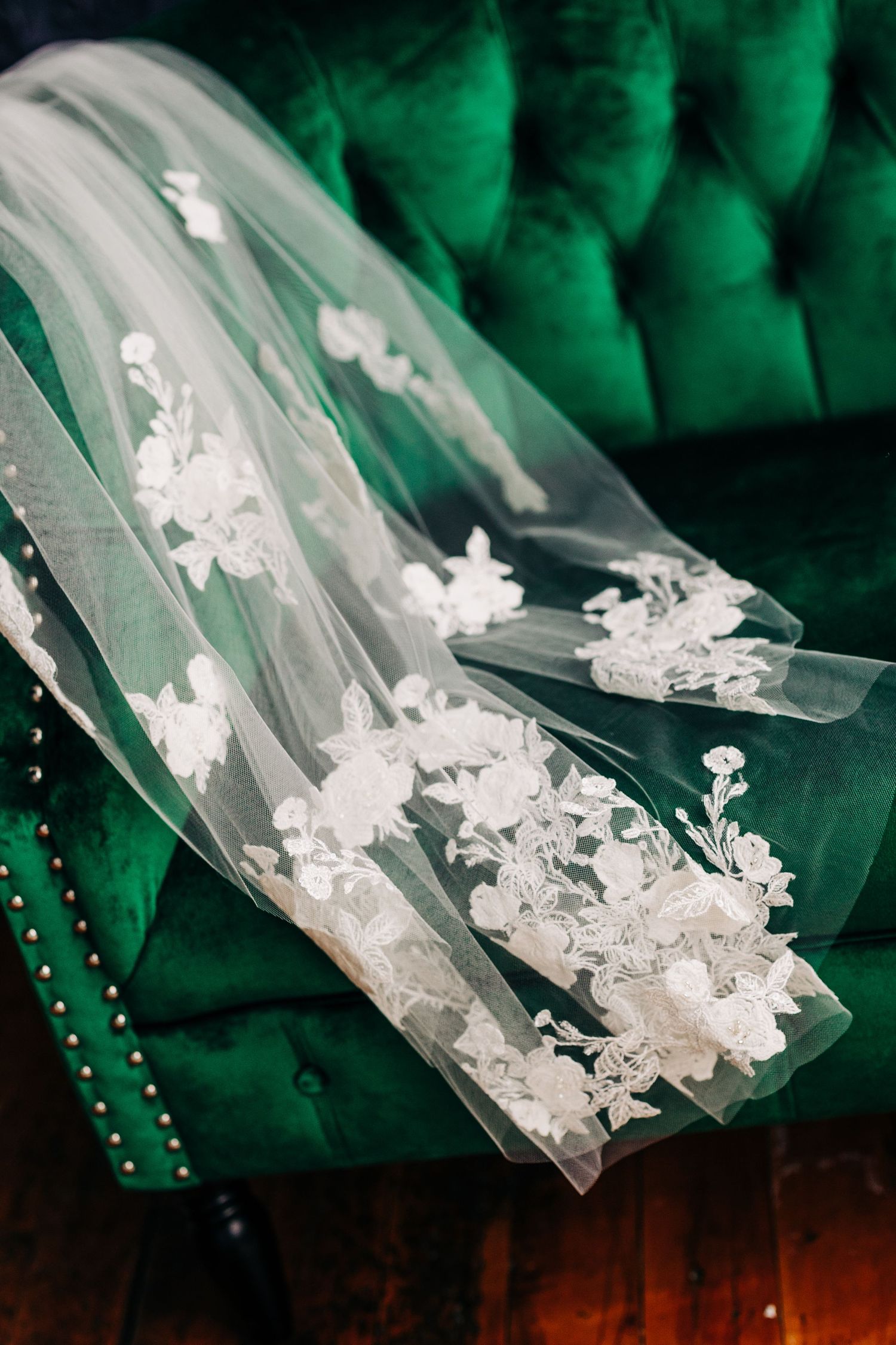 Small plastic bags containing white crystal methamphetamine drugs arranged in a row against dark background with green lighting.