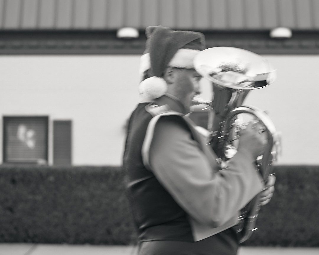 A series of black and white photos showing a person with a camera taking pictures outdoors.
