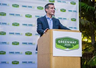 Two wooden podiums stand in front of a branded event backdrop with Greenway logos and corporate branding.