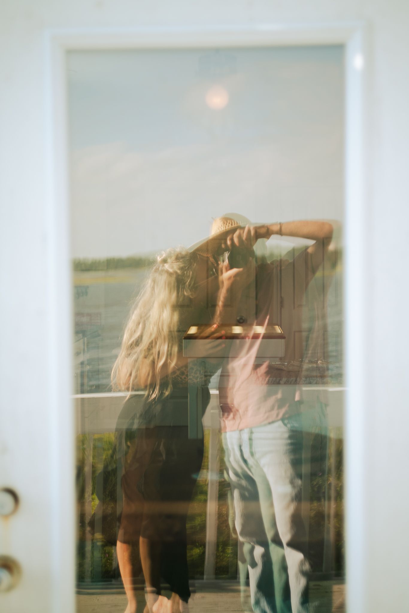 Artistic multiple exposure photograph showing movement against a window with soft natural lighting.