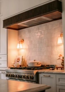Modern white kitchen with subway tile backsplash and warm under-cabinet lighting creates a cozy atmosphere.