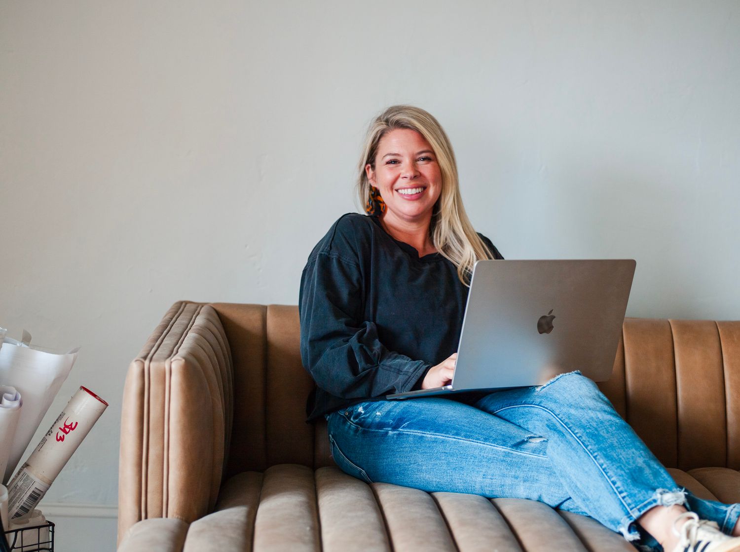Personal branding photo session in Albemarle NC with Lauren of Elle Luna Interior Design, relaxed lifestyle portrait on a leather couch.