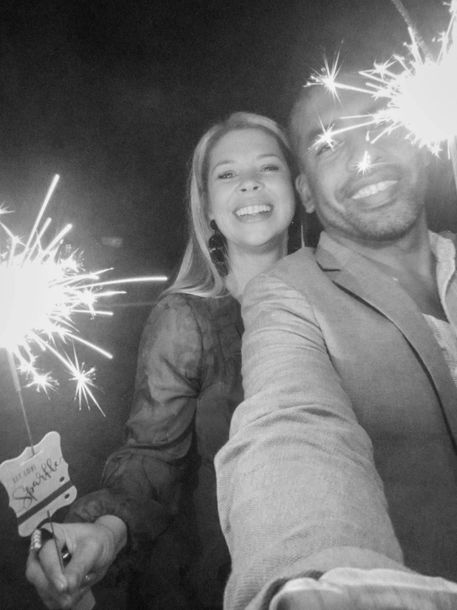 Multiple candid photos of people holding sparklers at night creating a festive atmosphere.