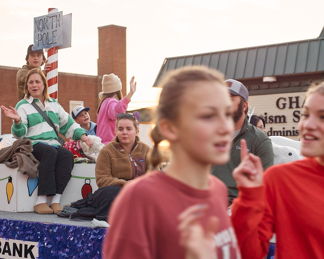 Crowd of protesters holding signs and gathering outside a building during a public demonstration.