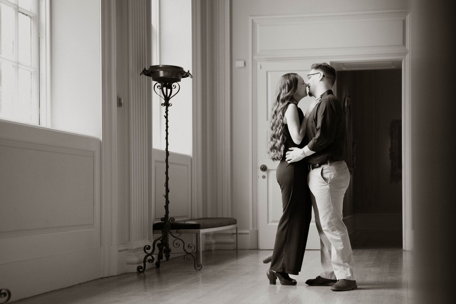 Black and white wedding photography series showing romantic couple moments in a luxurious bright interior setting.