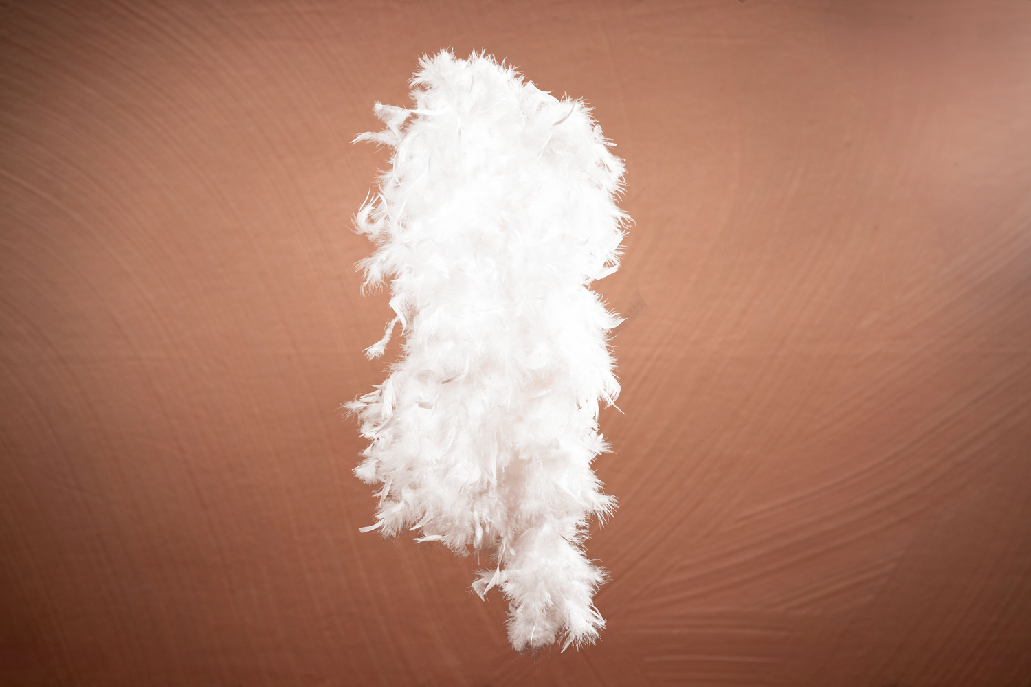 White smoke or fog effect swirling against brown background.