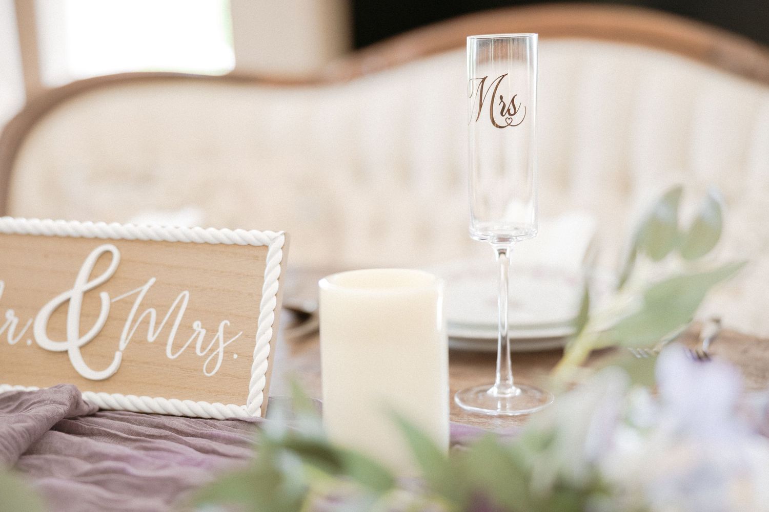 Elegant wedding reception table details with soft pastel colors and rustic decor elements in natural light.