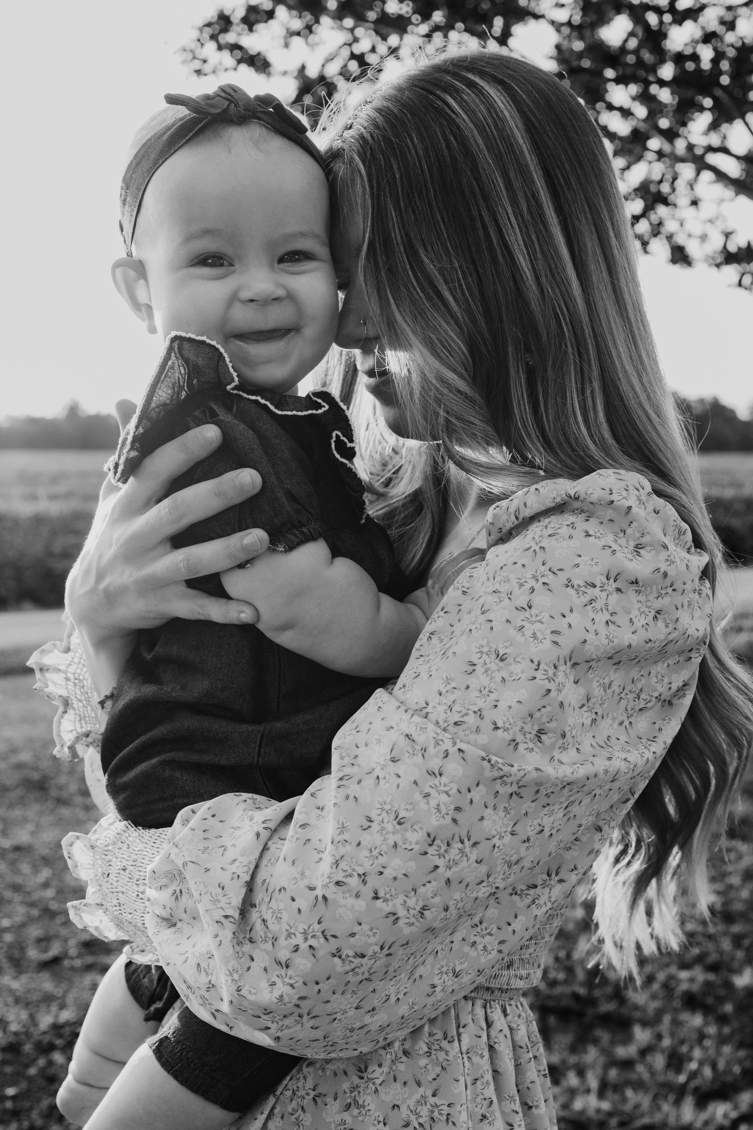 Black and white photo sequence showing sweet embraces and joyful moments between two figures in an outdoor setting.