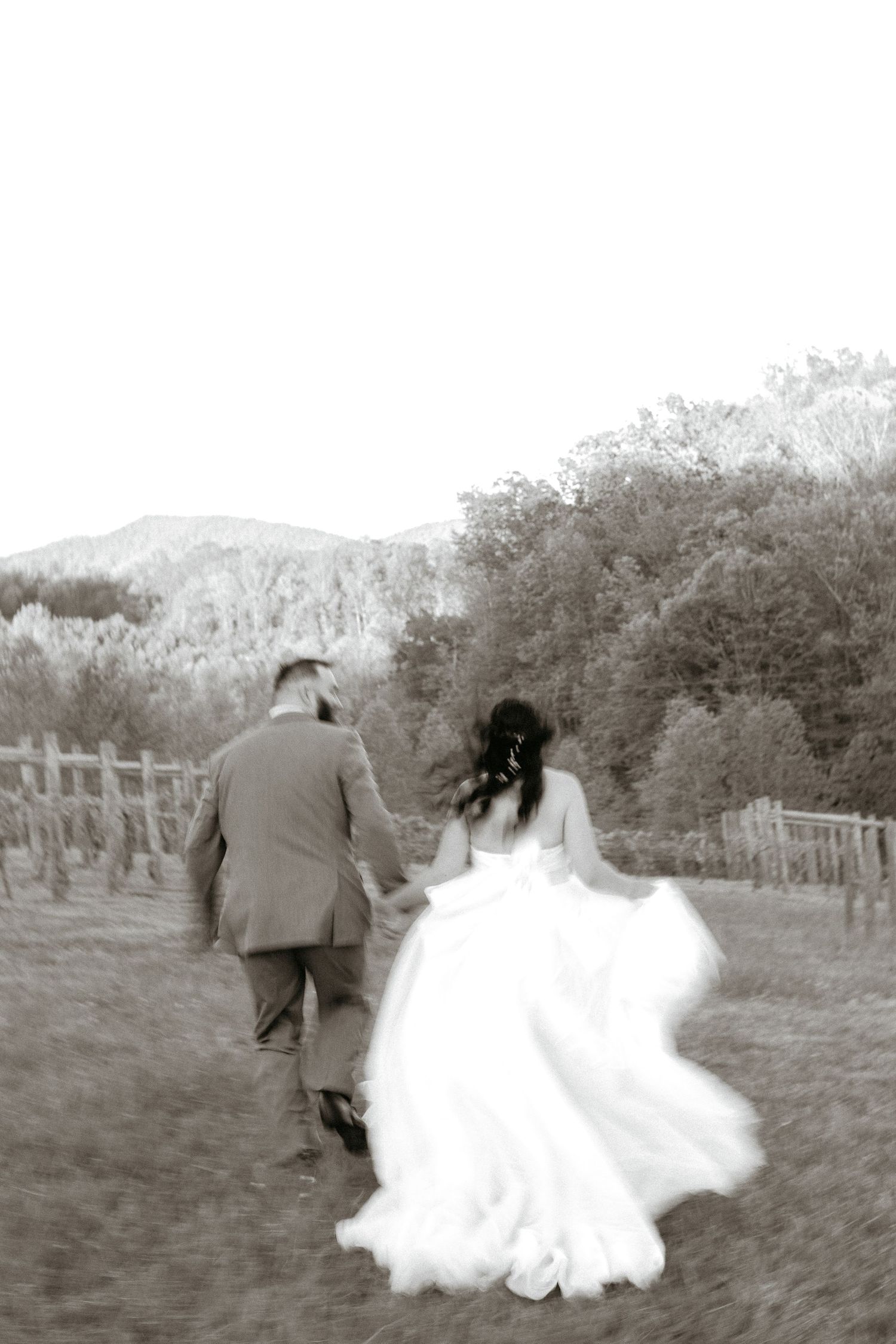 A romantic black and white wedding photo sequence shows newlyweds running playfully through a field together.