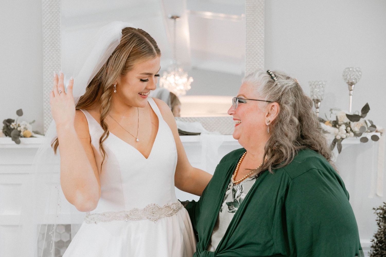 Wedding guests enjoying a joyful moment during an indoor reception celebration.